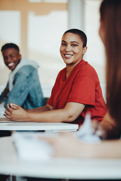 Smiling female student sitting in classroom
