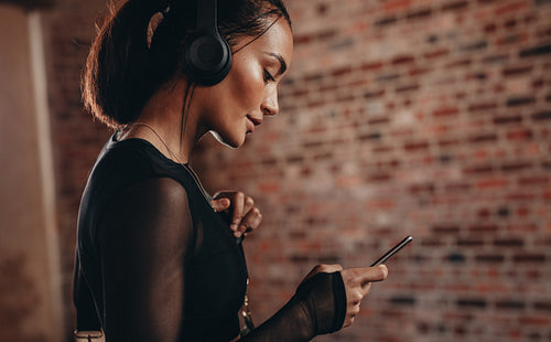 Woman in gym using mobile phone