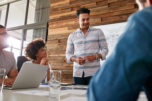 Group of young designers brainstorming in boardroom