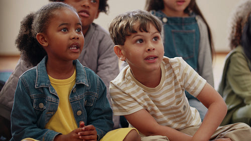 Early child development through nursery rhymes: Elementary school kids learning the alphabet song in a classroom
