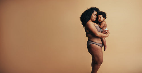 African american woman carrying her child