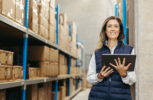 Happy warehouse manager smiling at the camera