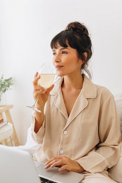 Close up of woman enjoying wine at home