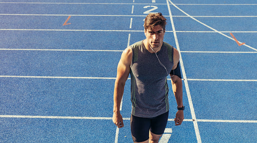 Sprinter standing on running track