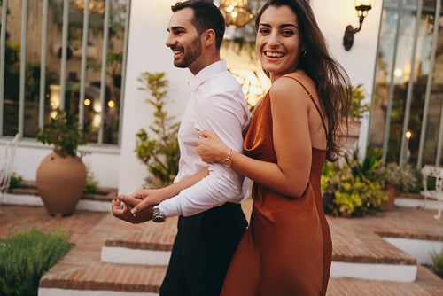 Excited young couple arriving for their honeymoon at a luxury ho