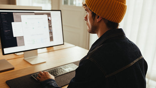 Desktop computer work: man focused at his desk in small office
