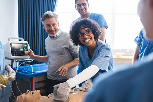 Clinical rotation in medical school: Medical students use a defibrillator in a CPR training class