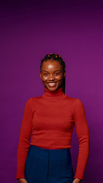 Young woman smiles for the camera in a colorful studio portrait