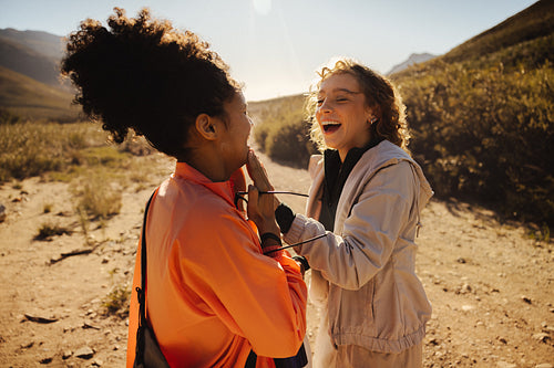 Friends laughing on a sunny trail