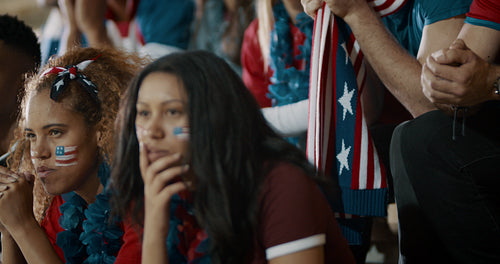 American soccer fans watching a game in stadium
