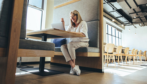 Mature entrepreneur having a virtual meeting in a  modern worksp