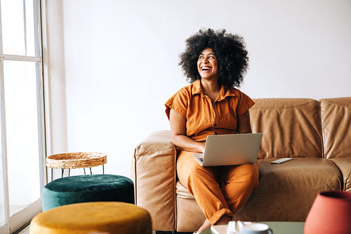 Thoughtful young businesswoman looking away with a smile