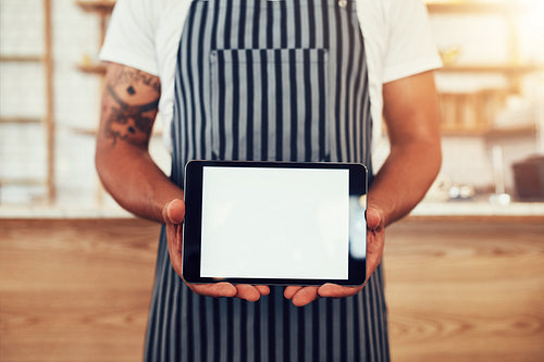Barista holding digital tablet