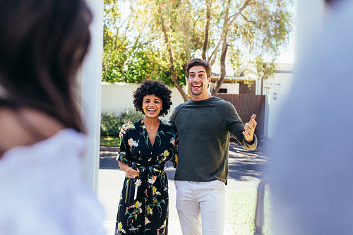 Excited couple being welcomed by friends