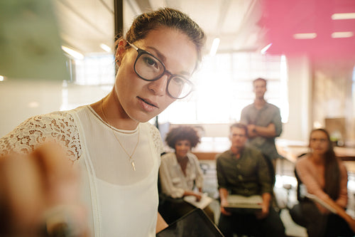 Female executive discussing business with team
