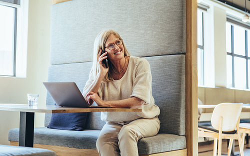 Happy mature businesswoman speaking on a phone call