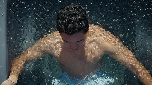Man in ice bath practicing cold plunge breathing for recovery and wellness