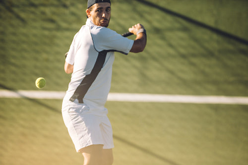 Tennis player hitting a powerful backhand
