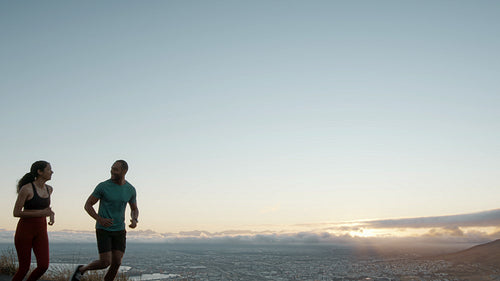 Fitness couple running together in nature