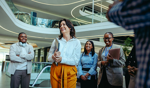 Energetic team of diverse professionals gather on the first day at the office building