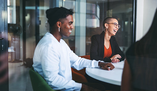 Cheerful businesspeople laughing in a meeting