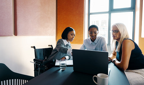 Team of diverse professionals working together in a modern office environment
