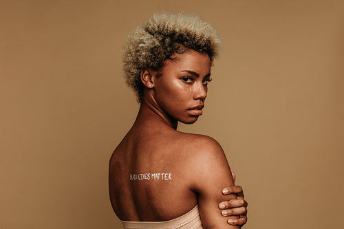 African american woman with writing on her back