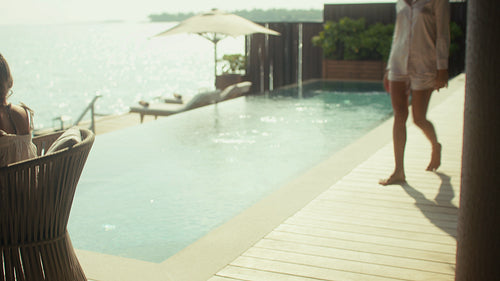 Family enjoys breakfast together at a luxurious overwater villa on a tropical vacation