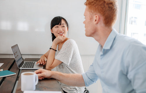 Two business people sitting at conference table