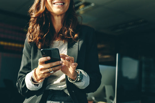 Businesswoman with a on mobile phone in office