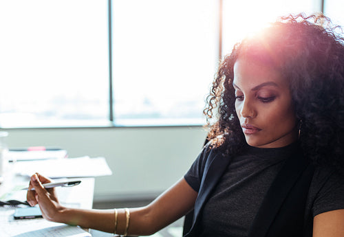 Businesswoman working at her desk in office.