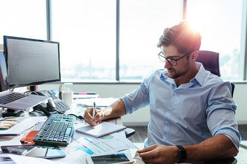 Businessman working at his desk in office.