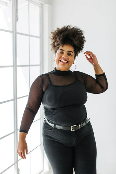 Woman in black outfit standing in living room