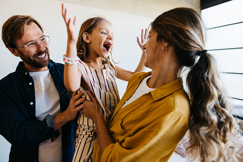 Family joy as parents cheer with daughter