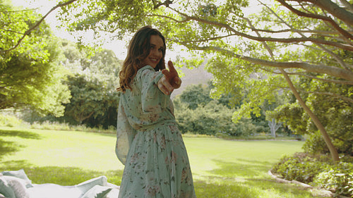 Cheerful woman running in a park