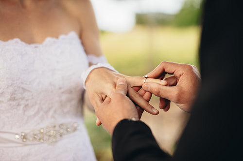 Couple exchanging wedding rings at ceremony