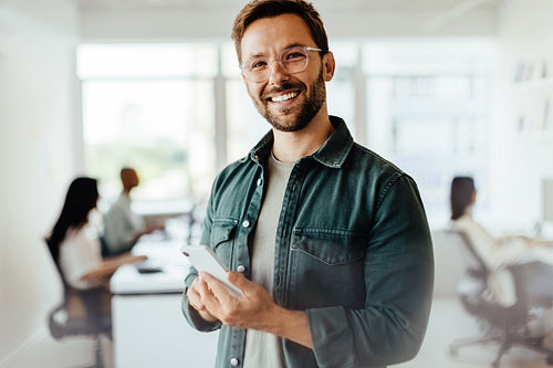 Man using a mobile phone in an office