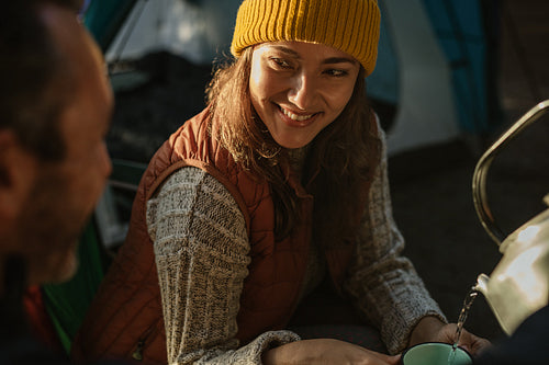 Couple camping in nature having coffee