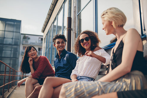Multiethnic group of friends in balcony and talking