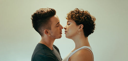 Affectionate queer couple going in for a kiss