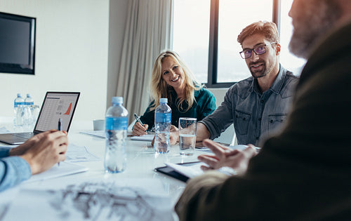 Young businessman in meeting with coworkers