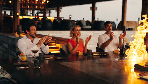 Friends enjoying a gourmet dining experience at a stylish restaurant setting