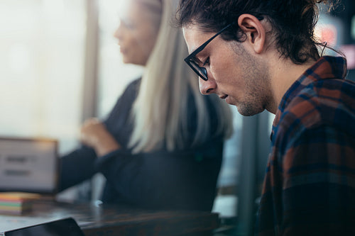 Young man sitting in meeting at office