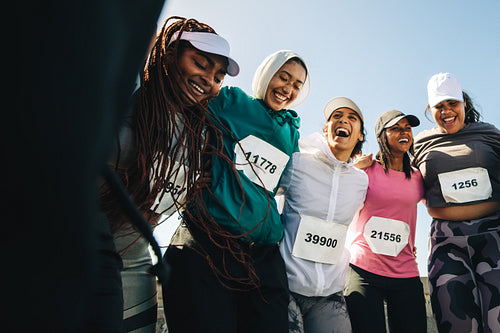 Women embracing friendship after marathon race victory