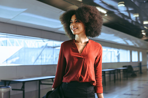 Smiling female passenger at airport terminal