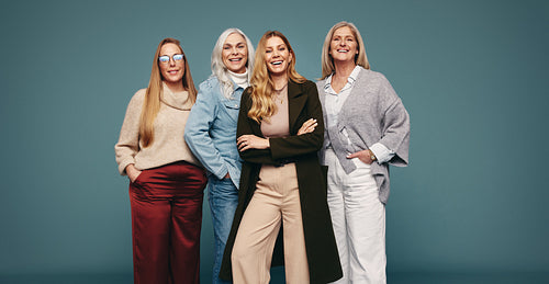 Cheerful mature women smiling in a studio