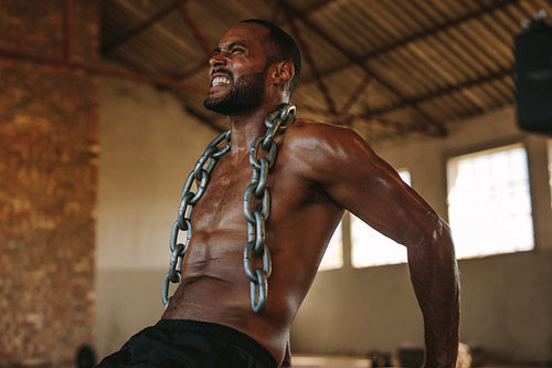 Tough man doing triceps dips exercise