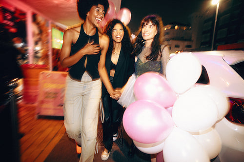 Group of friends enjoying a cheerful night out on the city streets