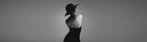 Banner of glamorous woman in black dress and hat