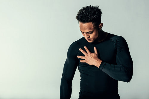 Handsome muscular man standing over grey background